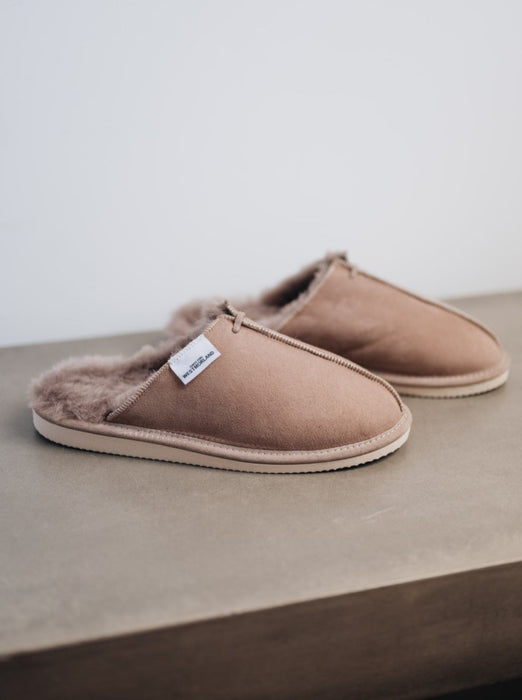 stone grey coloured slip on sheepskin slippers with centre seam stitching detail and contrasting white tag