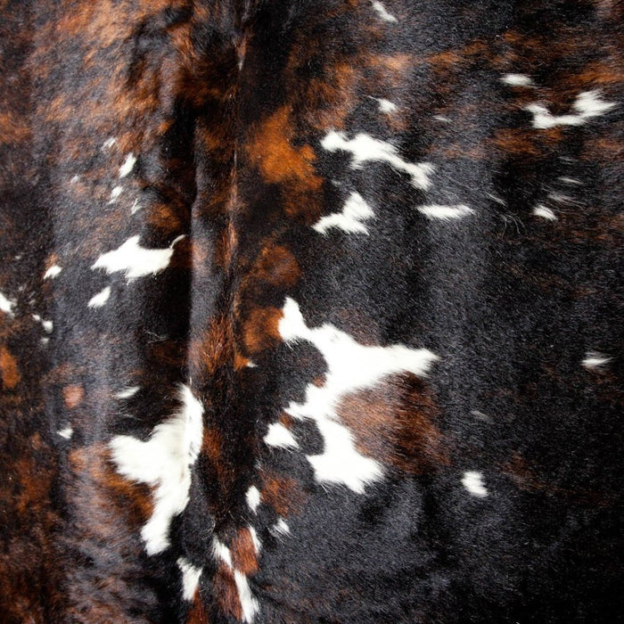 White, Deep warm Brown and near Black Cowhide Rug. Shows natural spotted print.