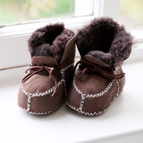 Brown baby booties with white stitch detailing, sheepskin inner and brown laces.