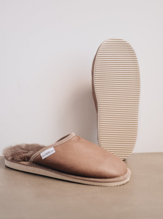 Men's slip on sheepskin slippers in a stone colour, featuring a hard foam sole and napa finish
