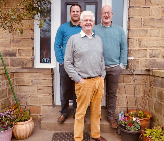 Tim, Howard and Joe, the Heaton Family, stood outside house.