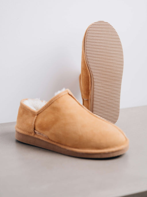 Side and Bottom view of CADI in Mel Sheepskin Unisex Slipper, designed by Westmorland Sheepskins. Features a small branded cork tag sewn into outer trim.