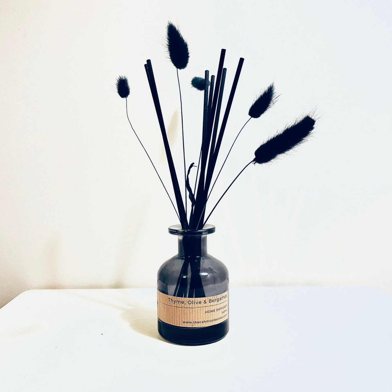 Cahm olive, thyme and bergamot glass reed Diffuser, in black glass vase with black reeds.