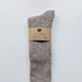 Anna Lungo Wool/Alpaca/Cotton/Hemp Long stone colour socks. Wrapped with a brown information band.