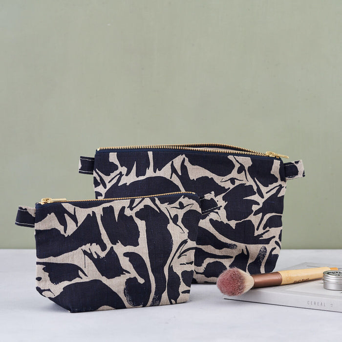 Large and Small Blästa Henriët Linen Wash Bags with Navy Blue Small Creatures Abstract Pattern. Features gold zip.