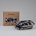 Folded Navy Blue Small Creatures Abstract Pattern Blästa Henriët Wheat Bag. Next to it, a boxed Wheat Bag in Brown Cardboard Packaging.