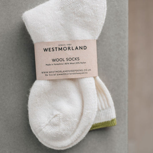 Green trimmed wool lounge socks in sustainable packaging from Westmorland Sheepskins