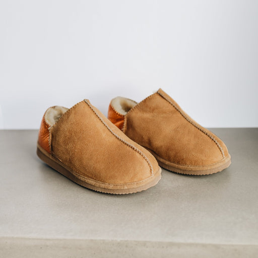 Upper view of CADI Tan Sheepskin Women's Slipper, designed by Westmorland Sheepskins. The ankle has a contemporary Orange Foil look. Features a small branded cork tag sewn into outer trim.