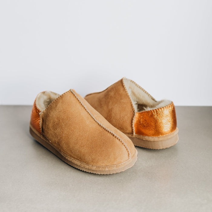 Front and back view of CADI Tan Sheepskin Women's Slipper, designed by Westmorland Sheepskins. The ankle has a contemporary Orange Foil look. Features a small branded cork tag sewn into outer trim.
