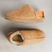 Side and top down view of CADI Tan Sheepskin Women's Slipper, designed by Westmorland Sheepskins. The ankle has a contemporary Orange Foil look. Features a small branded cork tag sewn into outer trim.