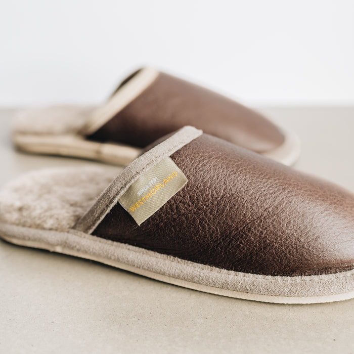Walnut Brown colour of Huw Slip On Sheepskin Slippers. Close up of westmorland branded sewn in tag on upper trim.