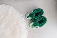 Top down view of Westmorland Sheepskins Soft Soled Metallic Mint (green) foil Baby Sheepskin Boots with a green Sheepskin Cuff and laces.