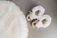 Top view of Westmorland Sheepskins Soft Soled Metallic Platinum (light gold) foil Baby Sheepskin Boots with a white Sheepskin Cuff and laces.