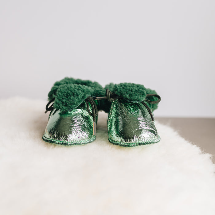 Front view of Westmorland Sheepskins Soft Soled Metallic Mint (green) foil Baby Sheepskin Boots with a green Sheepskin Cuff and laces.