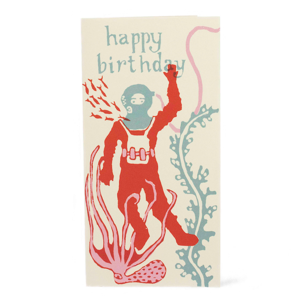 Happy Birthday card. A long verticle card, features a Deep Sea Diver in a red diving suit and blue headgear. Around him are nautical creatures and seaweed. At the top of the card in light blue writing reads 'happy birthday'. Comes with an envelope.