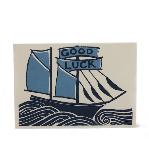 Good luck Greetings Card. A horizontal card, with an illustrative blue ship on choppy waters, with the writing 'Good Luck' written on its sales. Comes with envelope.