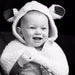 Little Lamb Wool Baby cape, image shows baby smiling and wearing Baby cape.