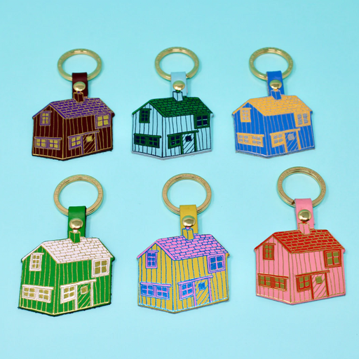 Ark's Leather Various Colour Cabin Keyrings. Features a variety of multicolour cabin keyrings in complimentary colours, including pink and red, yellow and pink, and blue and yellow. Comes on a gold foil background.