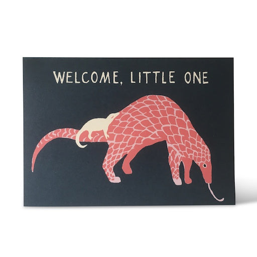 'Welcome, Little One' Designed Greetings Card. A horizontal rectangular card with a charcoal grey background features a pink Pangolin with a small white baby Pangolin asleep on its tail. At the top of the card reads 'Welcome, Little One' in white writing. Comes with an envelope. 