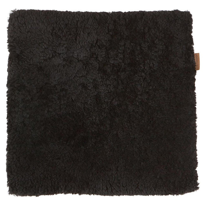 Jill, a black square Sheepskin seat pad, made by Shepherd of Sweden. Small Shepherd branded tag sewn in.