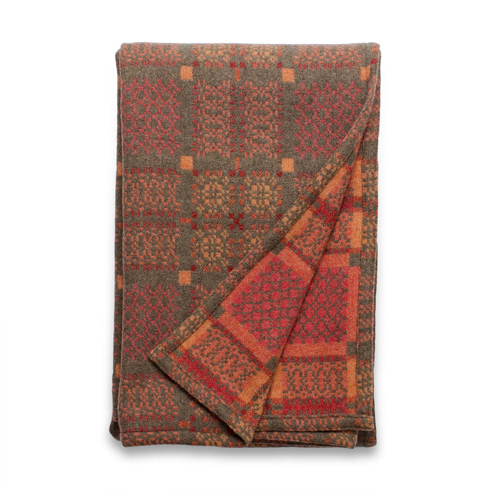 Copper Orange Melin Tregwynt Knot Garden Woven Wool Throw. A rusty copper colour, with detail pattern in rust red, pale orange and grey.