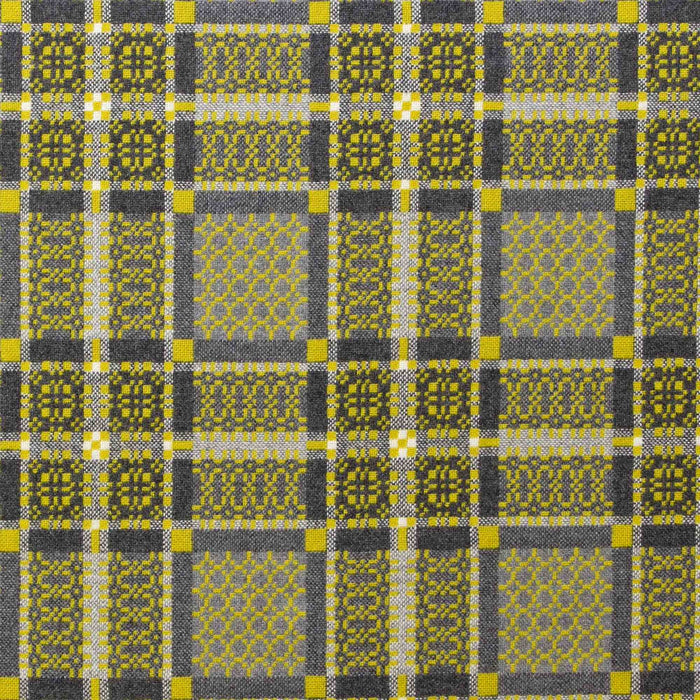 Gorse reverse fabric for Yellow Melin Tregwynt Knot Garden Woven Wool Throw. A bright daffodil yellow colour, with detail pattern in charcoal grey, white and light grey.