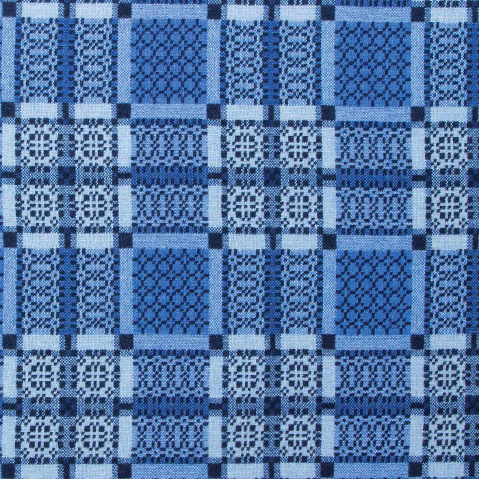 Indigo reverse fabric for Blue Melin Tregwynt Knot Garden Woven Wool Throw. A deep Indigo blue colour, with detail pattern in white, grey and light blue.