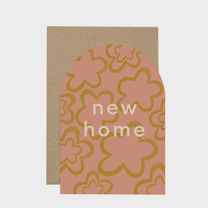 New Home Curved Card. A verticle curved topped card, features a simple pink and green flower shapes background. In the centre of the card reads 'new home' in simple modern white text. Comes with an envelope.